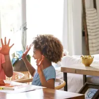 mother and daughter laughing at table