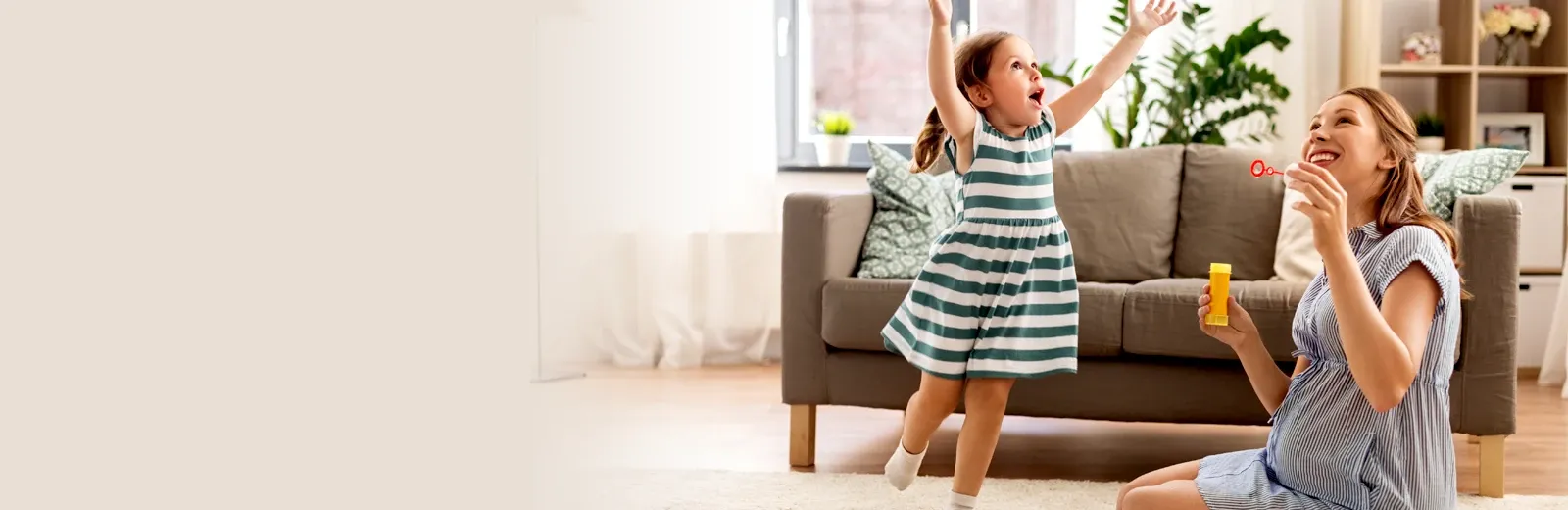 Mom and daughter playing in living room