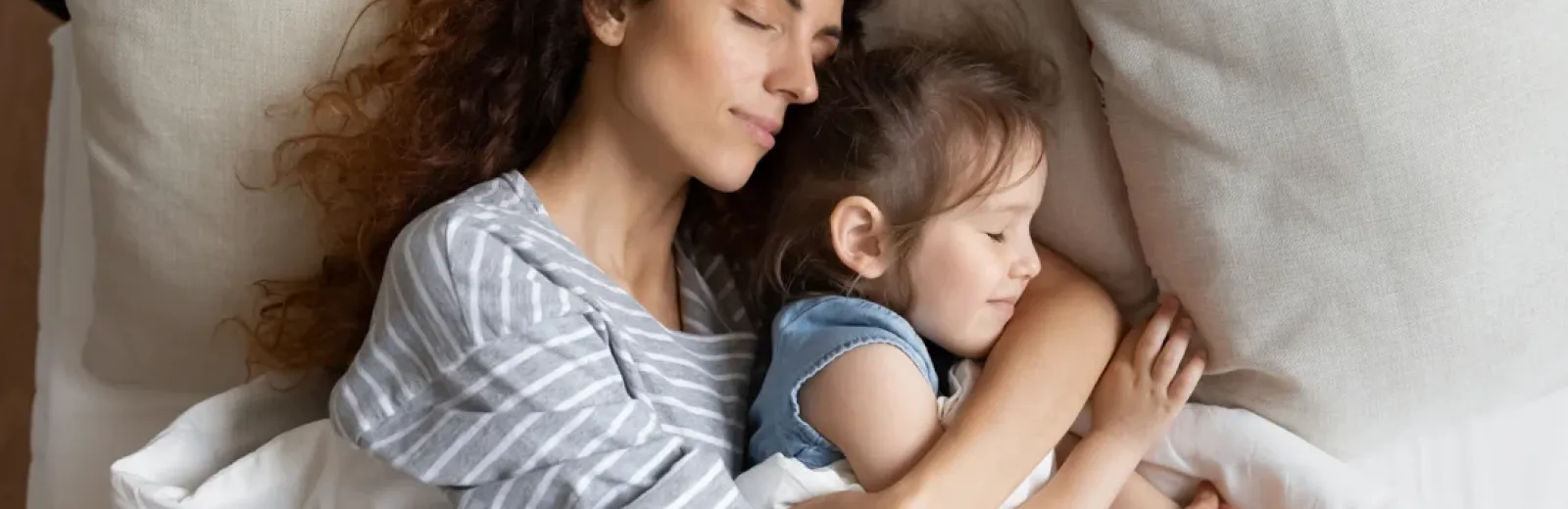 mother and daughter sleeping comfortably