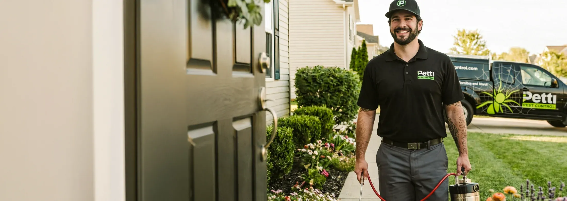 Petti Pest Control technician walking from truck to house